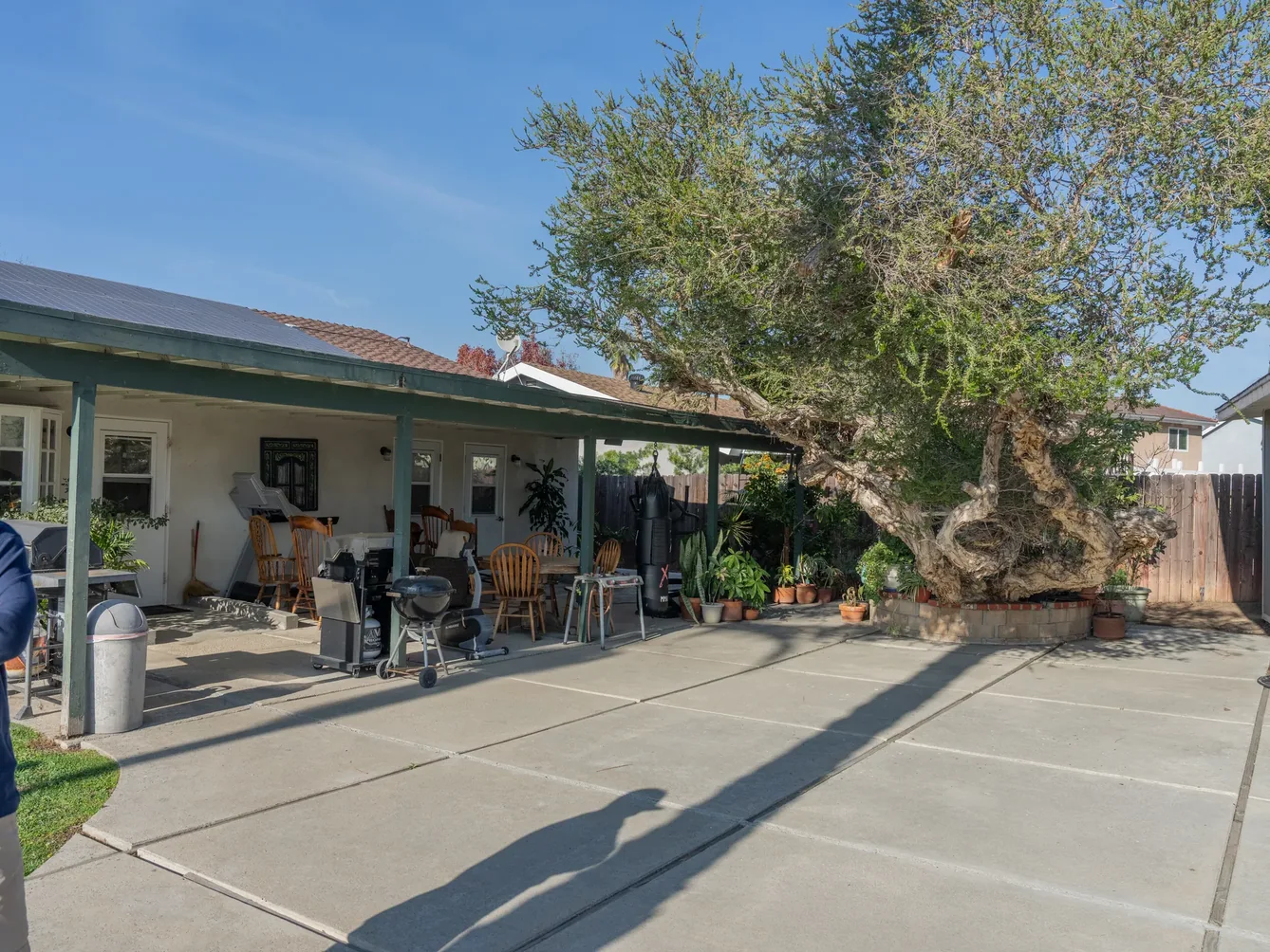 Spacious covered patio with outdoor dining area and shaded seating at residential care home